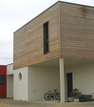 Vue extérieure d'une maison en ecologique bois réalisée avec un mur pré-usiné